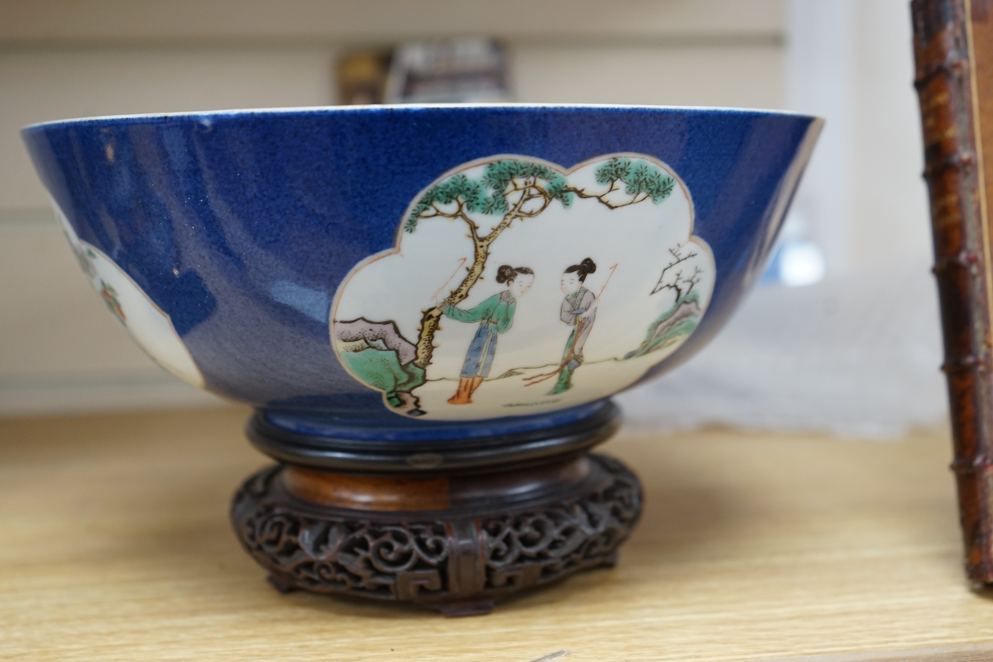 A 19th century Chinese famille verte powder blue bowl, 26cm diameter, wood stand